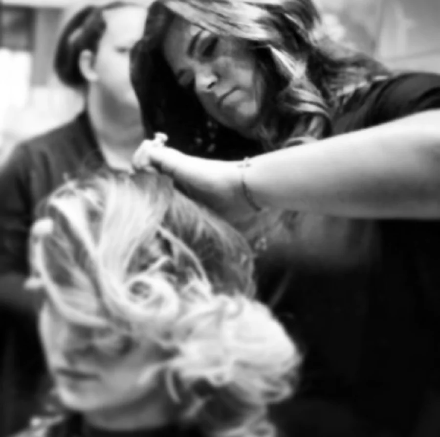 A Taylor Stevens stylist carefully working with a guest