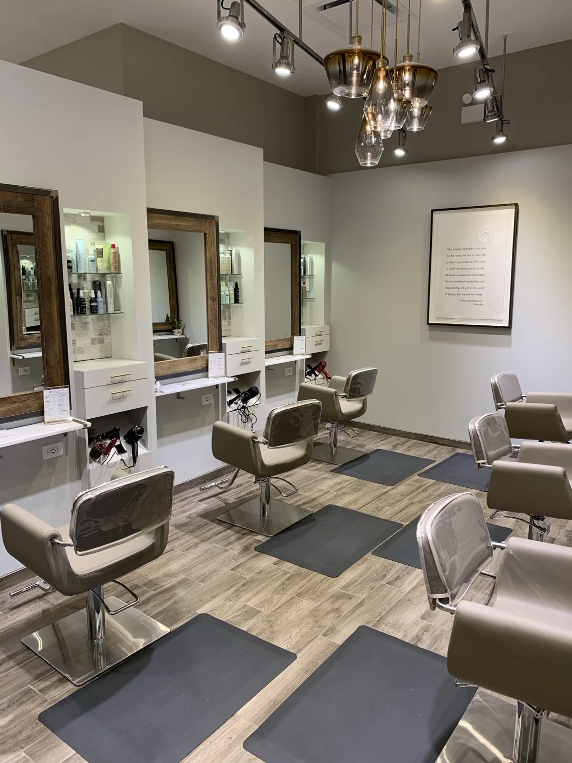 Styling stations and warm wood mirrors inside Taylor Stevens Salon