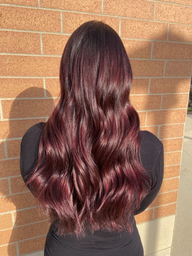 Rich burgundy waves at Taylor Stevens Salon
