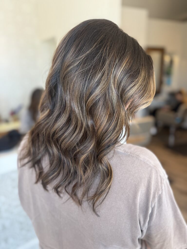Soft brunette waves with dimensional highlights at Taylor Stevens Salon