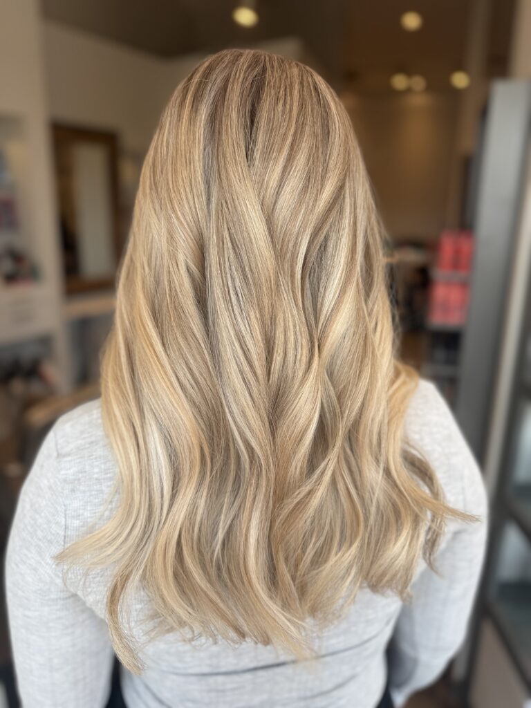 Soft Blonde Waves — Back View at Taylor Stevens Salon