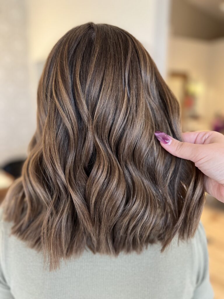 Brunette waves with caramel highlights at Taylor Stevens Salon